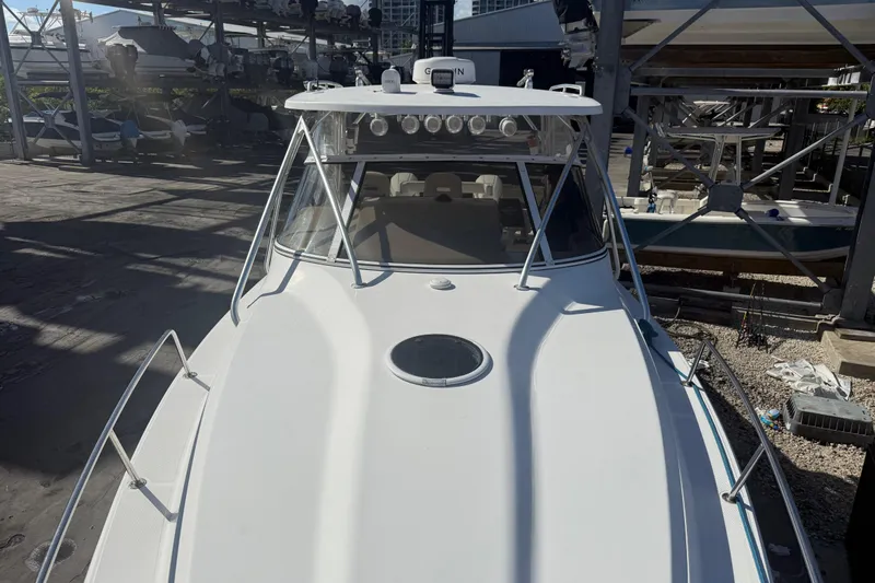  Yacht Photos Pics 2017 Fountain 38 Sportfish Cruiser docked, showcasing sleek design and spacious deck.