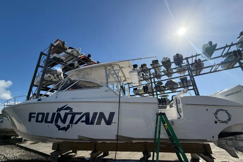 Yacht Photos Pics 2017 Fountain 38 Sportfish Cruiser boat in storage under bright sun.
