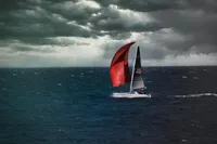 Sailing yacht Dehler 30, 2020 model, navigating stormy seas under dramatic skies.