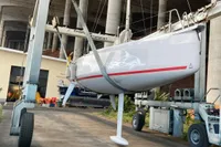 2020 Dehler 30 sailboat being lifted by a crane in a shipyard.