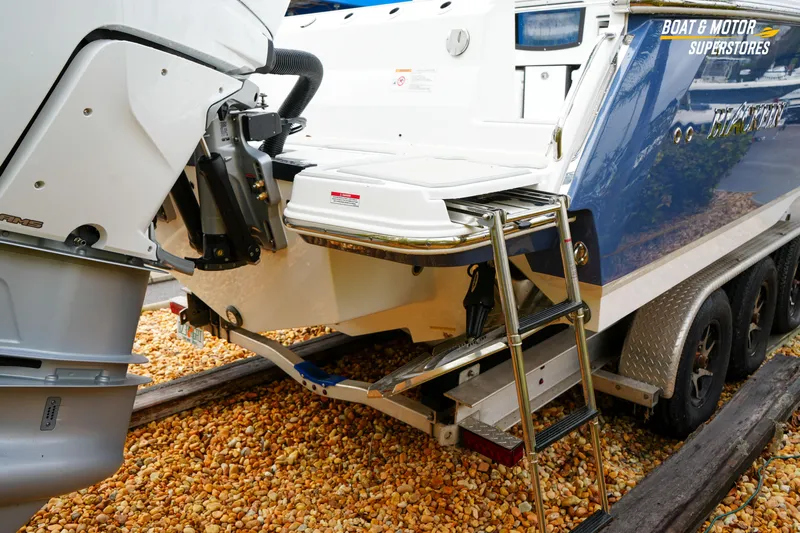  Yacht Photos Pics 2026 Blackfin 332 CC boat rear view with ladder and motor on trailer.