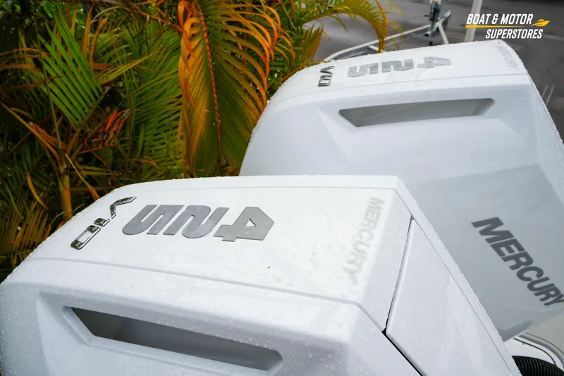  Yacht Photos Pics 2026 Blackfin 332 CC boat with Mercury engines, wet from rain, near tropical plants.