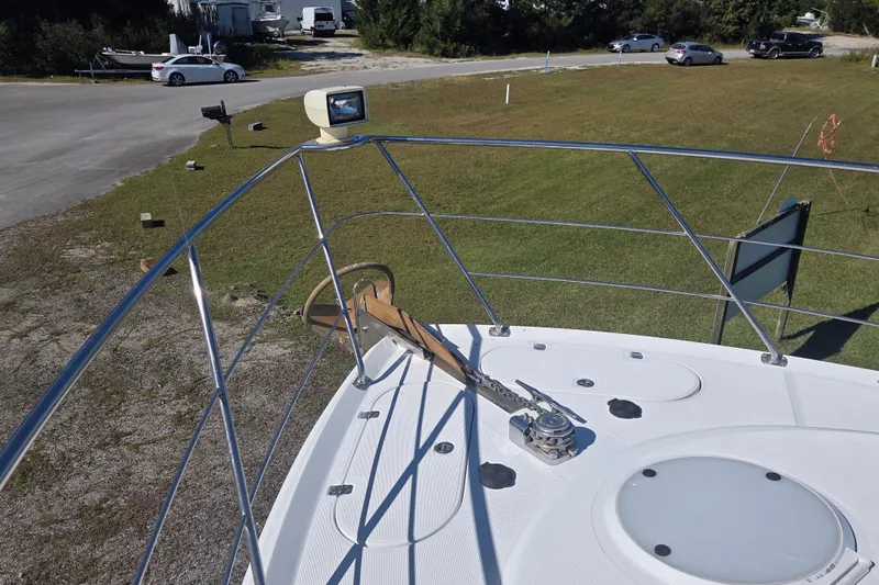 Pier Pressure Yacht Photos Pics Bow view of 2000 Carver 450 Voyager Pilothouse yacht with anchor and railing.