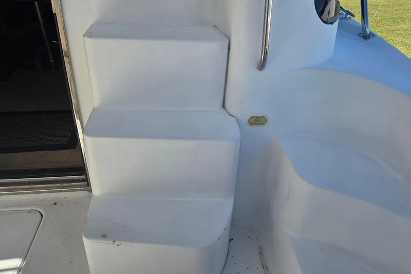 Pier Pressure Yacht Photos Pics Staircase on 2000 Carver 450 Voyager Pilothouse yacht, featuring sleek white design.