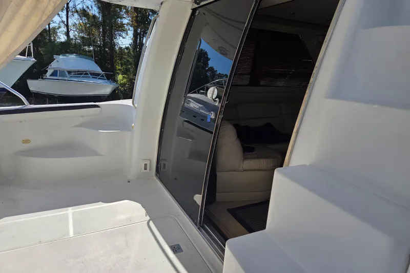 Pier Pressure Yacht Photos Pics 2000 Carver 450 Voyager Pilothouse yacht interior with open sliding door and visible seating area.