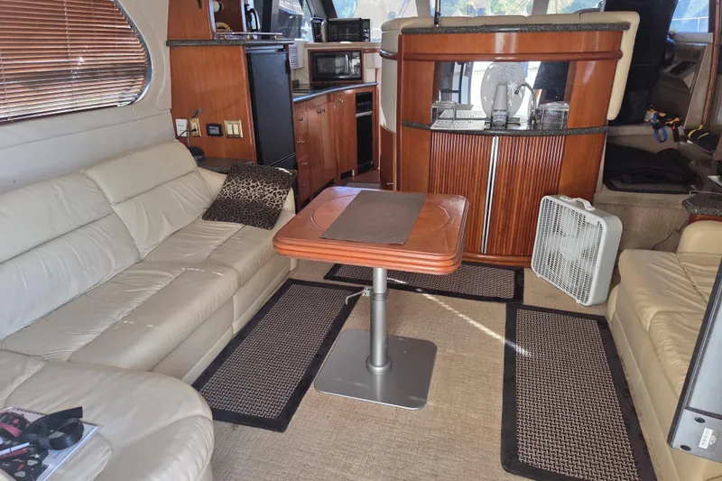 Pier Pressure Yacht Photos Pics Interior of 2000 Carver 450 Voyager Pilothouse with leather seating and wooden cabinetry.