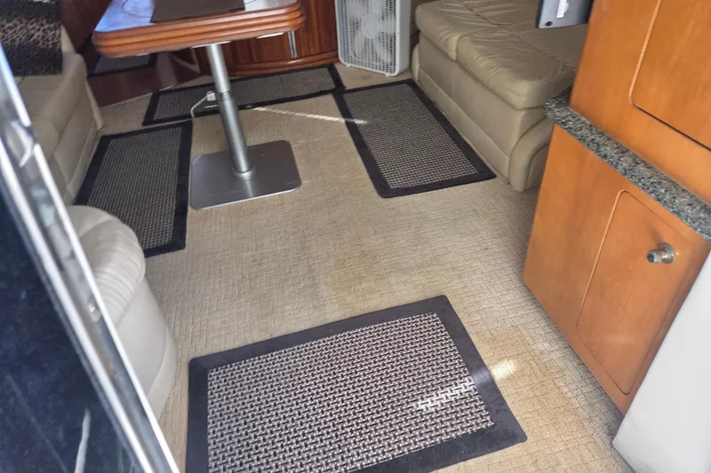 Pier Pressure Yacht Photos Pics Interior of 2000 Carver 450 Voyager Pilothouse with seating, table, and carpeted floor.