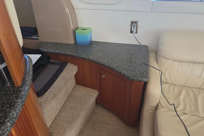 Pier Pressure Yacht Photos Pics Interior of 2000 Carver 450 Voyager Pilothouse with granite countertop and beige leather seating.