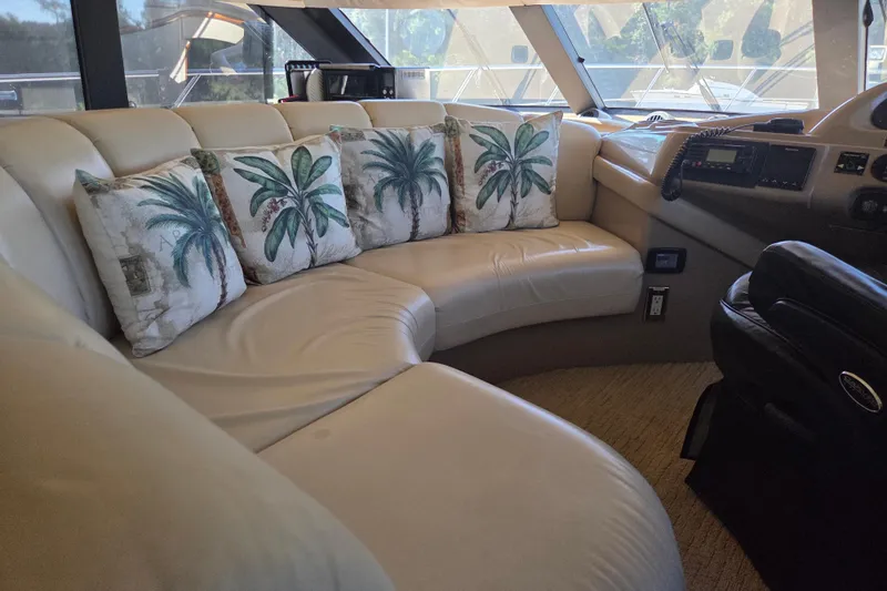 Pier Pressure Yacht Photos Pics Luxurious interior of 2000 Carver 450 Voyager Pilothouse with palm-themed cushions.