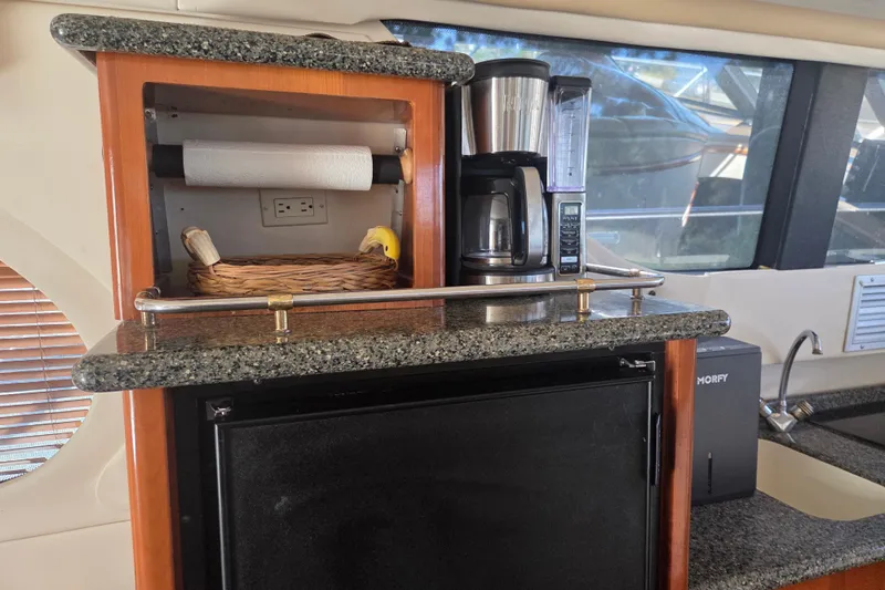 Pier Pressure Yacht Photos Pics Carver 450 Voyager Pilothouse 2000 yacht kitchen with coffee maker and granite countertop.