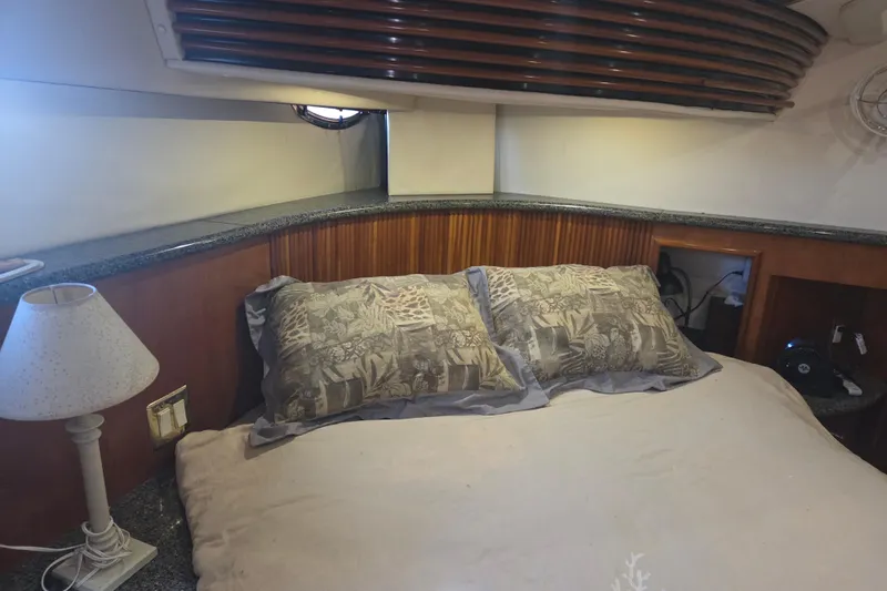 Pier Pressure Yacht Photos Pics Cozy bedroom in 2000 Carver 450 Voyager Pilothouse yacht with elegant wood paneling.