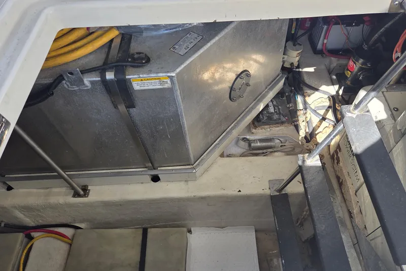 Pier Pressure Yacht Photos Pics Engine compartment of a 2000 Carver 450 Voyager Pilothouse with visible fuel tank and wiring.