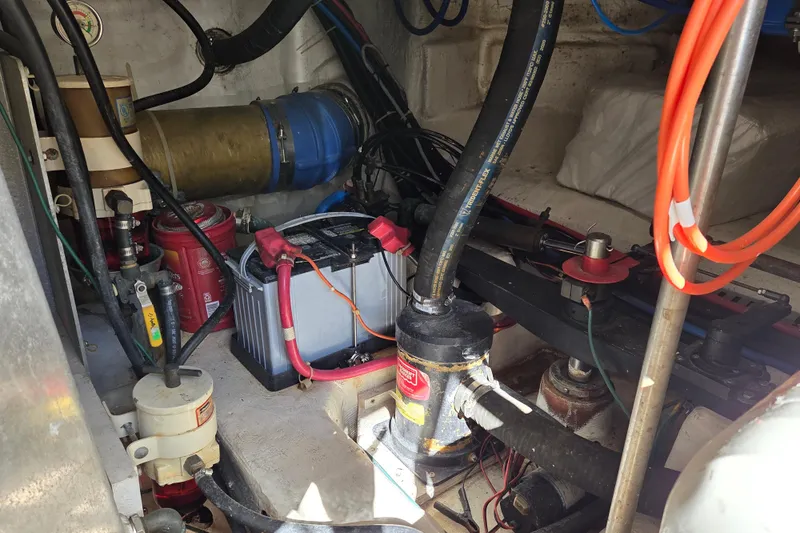 Pier Pressure Yacht Photos Pics Engine room of 2000 Carver 450 Voyager Pilothouse with visible battery and hoses.