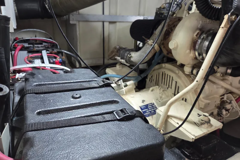 Pier Pressure Yacht Photos Pics Engine room of 2000 Carver 450 Voyager Pilothouse with visible battery and machinery components.