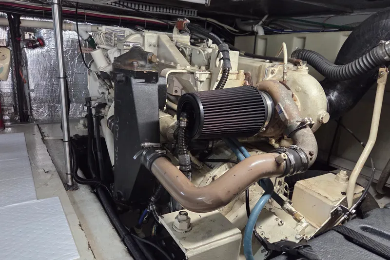 Pier Pressure Yacht Photos Pics Engine room of a 2000 Carver 450 Voyager Pilothouse yacht, showcasing mechanical components.