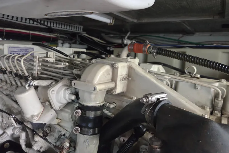 Pier Pressure Yacht Photos Pics Engine compartment of a 2000 Carver 450 Voyager Pilothouse, showcasing detailed mechanical components.