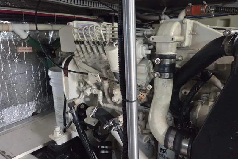 Pier Pressure Yacht Photos Pics Engine room of a 2000 Carver 450 Voyager Pilothouse yacht, showcasing mechanical components.