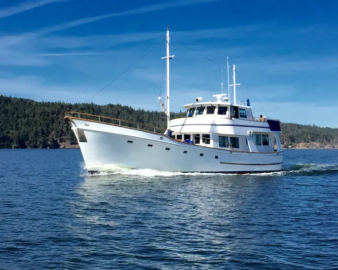 Shackleton Yacht Photos Pics 1982 Miller Marine North Sea Trawler cruising on calm waters under a clear blue sky.