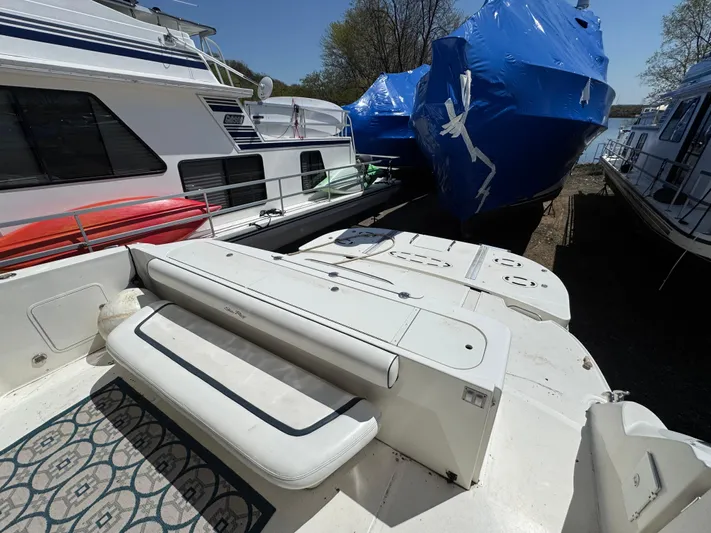 Current Affair Yacht Photos Pics 2005 Sea Ray 500 Sedan Bridge Fresh Water yacht docked with covered boats nearby.