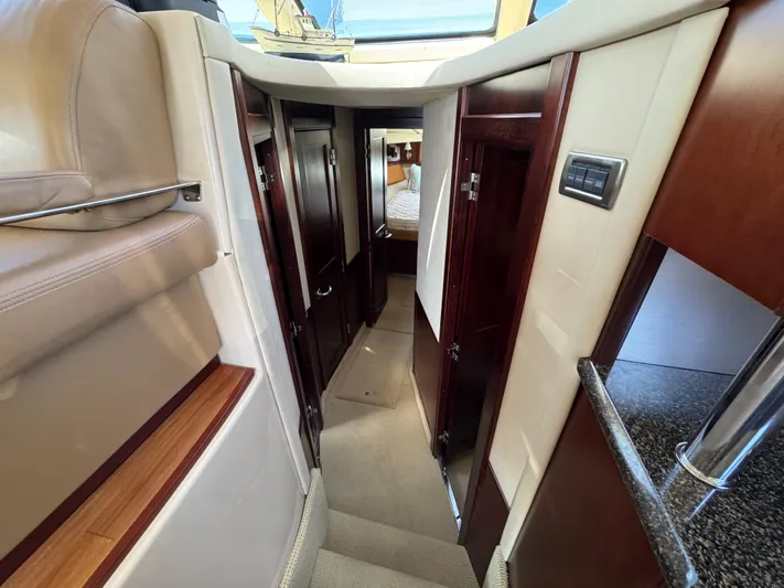 Current Affair Yacht Photos Pics Interior hallway of 2005 Sea Ray 500 Sedan Bridge yacht, featuring wood accents and modern design.