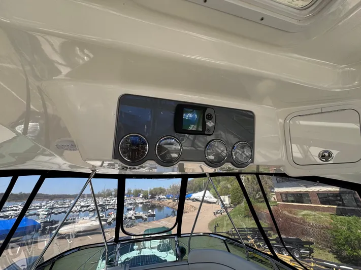Current Affair Yacht Photos Pics 2005 Sea Ray 500 Sedan Bridge helm with gauges and marina view.
