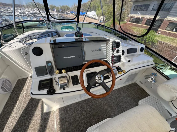 Current Affair Yacht Photos Pics 2005 Sea Ray 500 Sedan Bridge helm with Garmin and Raymarine navigation systems.