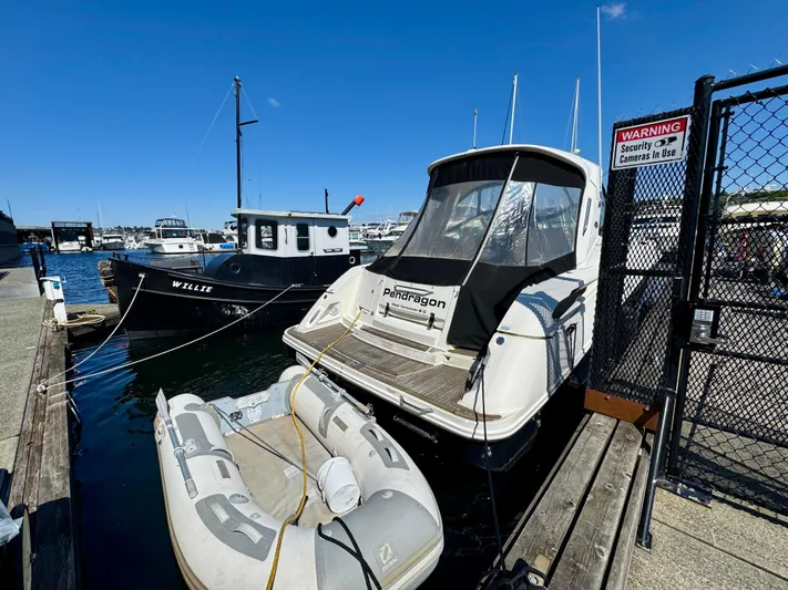 Pendragon Yacht Photos Pics 2009 Sea Ray 350 Sundancer docked with inflatable boat nearby, sunny marina setting.