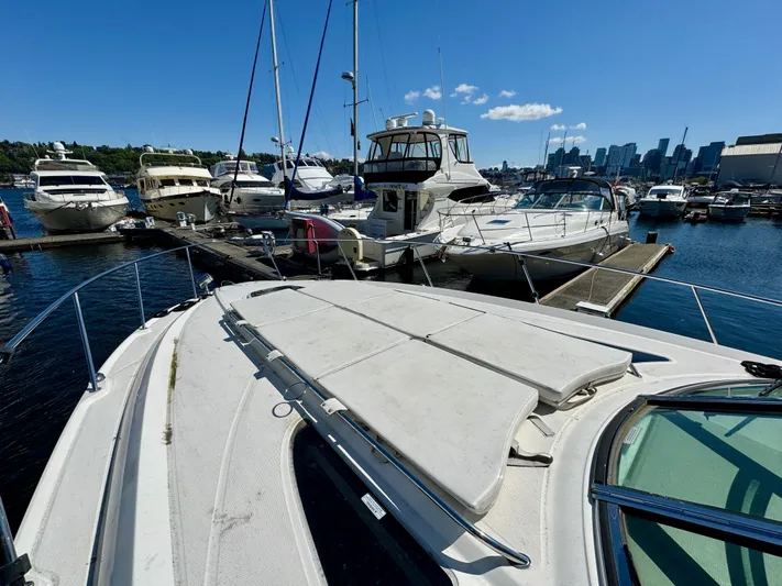 Pendragon Yacht Photos Pics 2009 Sea Ray 350 Sundancer docked at marina with city skyline in background.