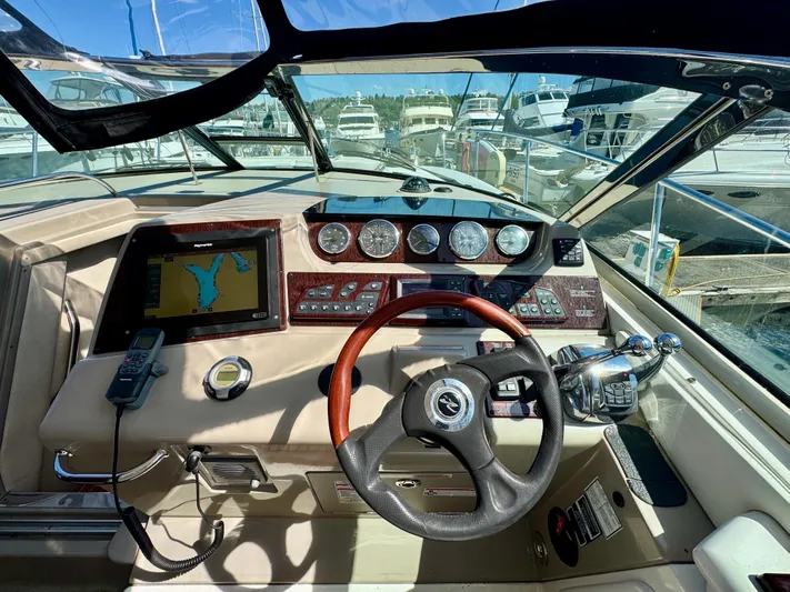 Pendragon Yacht Photos Pics Cockpit of 2009 Sea Ray 350 Sundancer with navigation system and steering wheel.