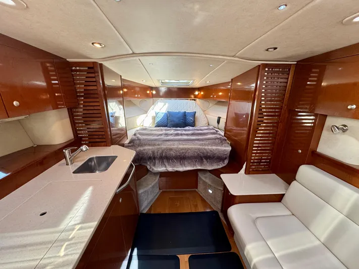 Pendragon Yacht Photos Pics Luxurious interior of 2009 Sea Ray 350 Sundancer yacht with bed, sink, and seating area.