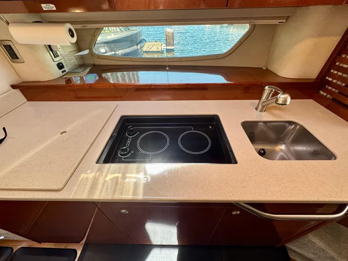 Pendragon Yacht Photos Pics 2009 Sea Ray 350 Sundancer yacht kitchen with stove, sink, and window view.