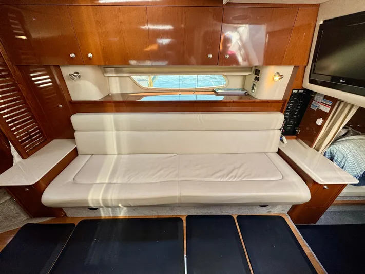 Pendragon Yacht Photos Pics Interior of 2009 Sea Ray 350 Sundancer with white leather seating and wooden cabinetry.
