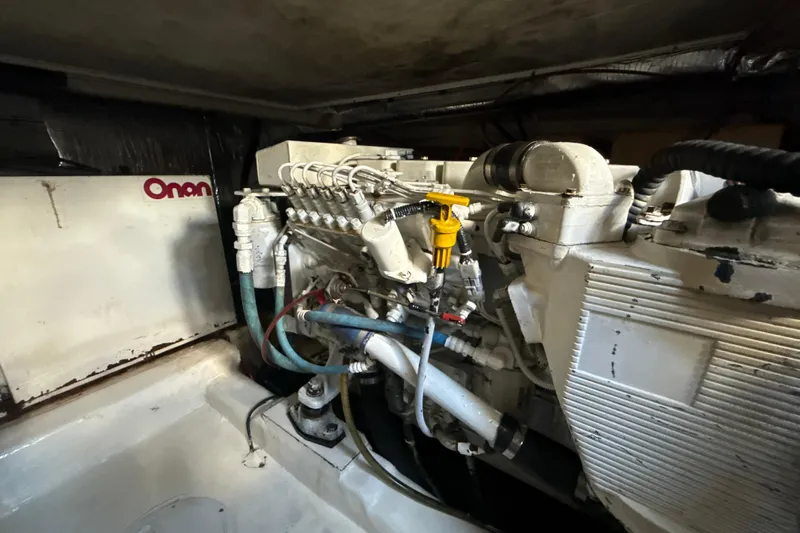  Yacht Photos Pics Engine room of 2003 Riviera 37 Flybridge with Onan generator and mechanical components.