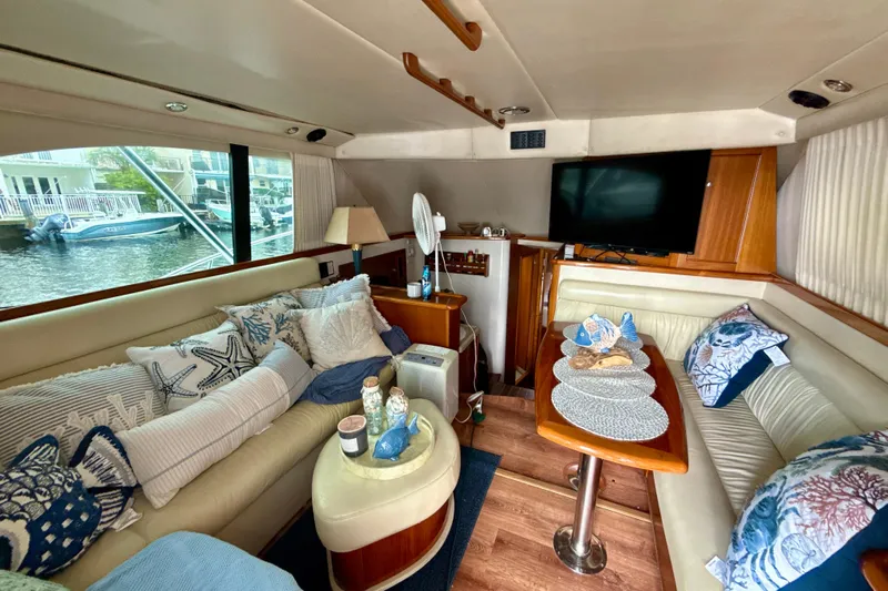  Yacht Photos Pics Luxurious interior of 2003 Riviera 37 Flybridge yacht with cozy seating and decor.