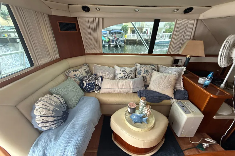  Yacht Photos Pics Luxurious interior of 2003 Riviera 37 Flybridge yacht with cozy seating and decorative pillows.
