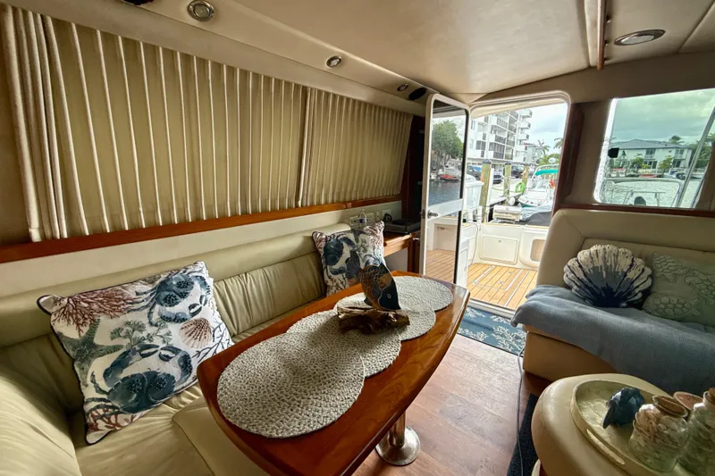  Yacht Photos Pics Luxurious interior of 2003 Riviera 37 Flybridge yacht with elegant decor and marina view.