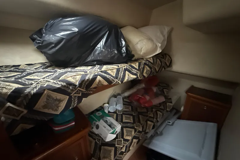  Yacht Photos Pics Interior cabin of 2003 Riviera 37 Flybridge with bunk beds and storage items.