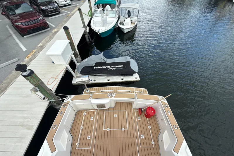  Yacht Photos Pics 2003 Riviera 37 Flybridge at dock with jet ski and boats nearby.