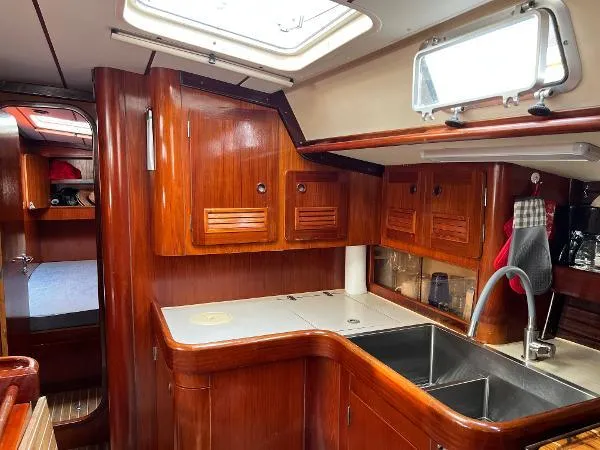  Yacht Photos Pics Interior of 1991 Beneteau Oceanis 510 yacht with wooden cabinetry and modern kitchen sink.