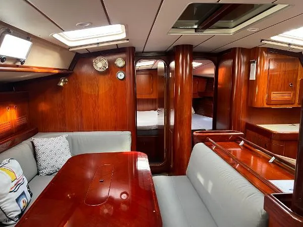  Yacht Photos Pics Interior of 1991 Beneteau Oceanis 510 sailboat with wood finish and cozy seating area.
