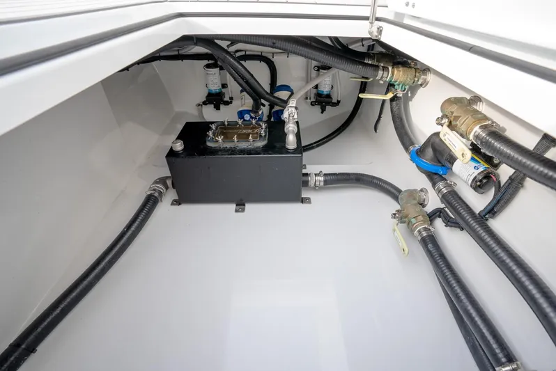  Yacht Photos Pics Interior view of a 2021 Freeman 47 boat's engine compartment with hoses and components.