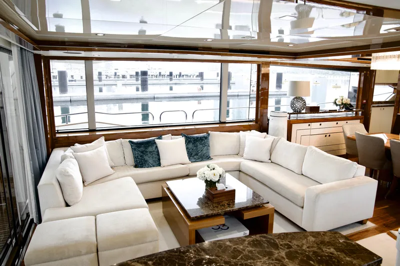  Yacht Photos Pics Luxurious interior of 2018 Sunseeker 95 Yacht with elegant white seating and large windows.
