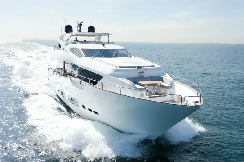  Yacht Photos Pics Luxurious 2018 Sunseeker 95 Yacht cruising on open sea under clear skies.