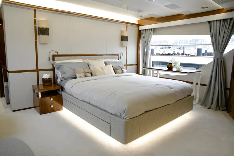  Yacht Photos Pics Luxurious bedroom interior of 2018 Sunseeker 95 Yacht with elegant decor and large window view.