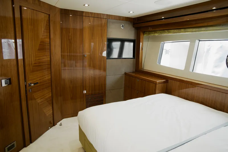  Yacht Photos Pics Luxurious Sunseeker 95 Yacht 2018 bedroom with elegant wood paneling and large windows.
