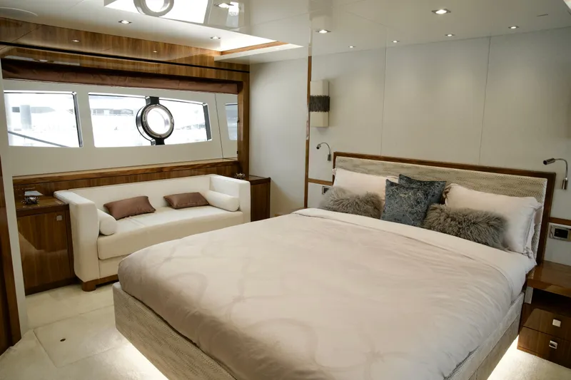  Yacht Photos Pics Luxurious bedroom interior of 2018 Sunseeker 95 Yacht with elegant furnishings and large bed.
