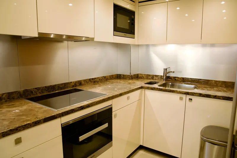  Yacht Photos Pics Modern kitchen in 2018 Sunseeker 95 Yacht with sleek countertops and built-in appliances.