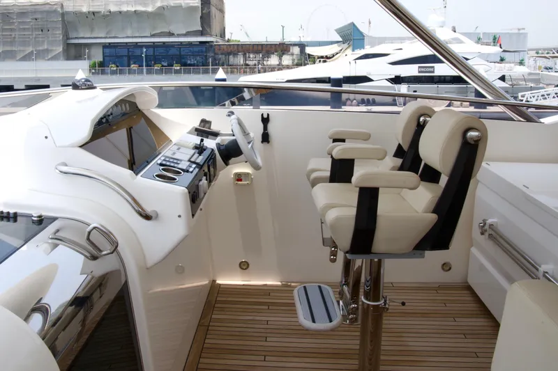  Yacht Photos Pics Luxurious helm of 2018 Sunseeker 95 Yacht with modern controls and seating.