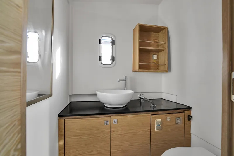 No Name Yacht Photos Pics Modern bathroom interior on 2019 Fjord 38 yacht with sleek sink and wooden cabinetry.