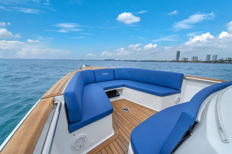 No Name Yacht Photos Pics Luxurious 2019 Fjord 38 boat with blue seating, wooden deck, and ocean view.